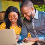 Woman and man on computer, innovative procurement